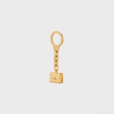 TRIOMPHE BAG CHARM IN BRASS .